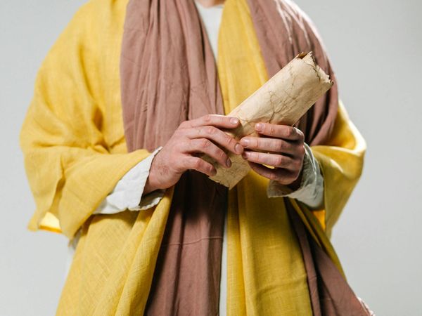 Ancient scroll with symbolic text representing the history of yoga.
